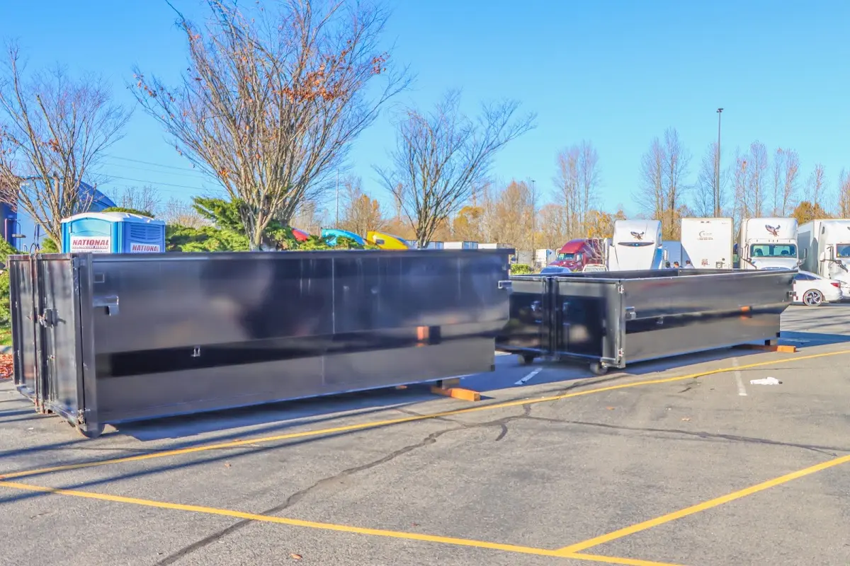 Professional dumpster rental service with roll-off container on residential driveway in Clermont